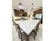 A bright and stylish kitchen features a large island, modern lighting, and stainless steel appliances at 6608 Harper Way, Harmony, FL 34773