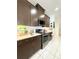 This kitchen showcases sleek cabinetry, stainless steel appliances, and white countertops for a modern look at 6608 Harper Way, Harmony, FL 34773