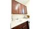 Cabinets and sink in well-organized laundry room at 6608 Harper Way, Harmony, FL 34773