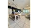 An open-concept living space featuring a dining table, tile floors, and a large sectional sofa at 6608 Harper Way, Harmony, FL 34773