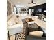 An open living room featuring modern decor, tile floors, and a large sectional couch at 6608 Harper Way, Harmony, FL 34773