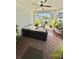 Covered patio with comfortable seating and a ceiling fan at 6608 Harper Way, Harmony, FL 34773