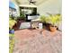 Inviting outdoor patio with stylish seating and lush landscaping at 6608 Harper Way, Harmony, FL 34773