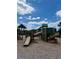 Community playground featuring slides, climbing structures, and shaded seating areas under a bright sky at 6608 Harper Way, Harmony, FL 34773