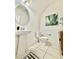 Bright powder room with pedestal sink, toilet, and stylish decor at 6608 Harper Way, Harmony, FL 34773