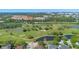 Picturesque aerial view of a lush golf course surrounded by serene ponds and upscale properties at 675 Celebration Ave, Celebration, FL 34747