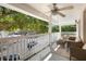 Relax on this lovely balcony, featuring cushioned seating, a ceiling fan, and scenic views at 675 Celebration Ave, Celebration, FL 34747