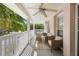 This charming balcony features comfortable seating and a cooling ceiling fan at 675 Celebration Ave, Celebration, FL 34747