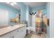 Well-maintained bathroom with a single sink vanity, a framed mirror, and a shower-tub combo at 675 Celebration Ave, Celebration, FL 34747