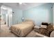 Bedroom featuring a comfortable bed, neutral color scheme, and adjacent bathroom entrance at 675 Celebration Ave, Celebration, FL 34747