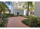Well-manicured landscaping and a brick path enhance the appeal of this courtyard at 675 Celebration Ave, Celebration, FL 34747