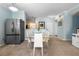 Contemporary dining area with a glass table, stainless steel refrigerator, and track lighting at 675 Celebration Ave, Celebration, FL 34747