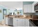Well-lit kitchen with ample cabinet space, stainless steel appliances, and cozy breakfast bar at 675 Celebration Ave, Celebration, FL 34747
