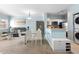 Cozy living area with glass dining table, modern kitchen appliances, and adjacent washer/dryer at 675 Celebration Ave, Celebration, FL 34747