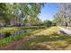 Peaceful street view with a canal, lush landscaping, and sidewalks enhancing the community's appeal at 675 Celebration Ave, Celebration, FL 34747