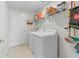 Functional laundry room with washer, dryer, and shelving for storage at 739 Peg Ct, St Cloud, FL 34772