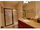 Bathroom featuring granite countertops, framed mirror, and a glass enclosed shower in a modern space at 7664 Wilmington Loop, Kissimmee, FL 34747