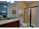 Well lit bathroom featuring granite countertops, and glass enclosed shower, perfect for a modern living experience at 7664 Wilmington Loop, Kissimmee, FL 34747