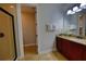 Bright bathroom featuring granite countertops, framed mirror, and a glass enclosed shower in a modern space at 7664 Wilmington Loop, Kissimmee, FL 34747