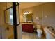 Bright bathroom featuring a double vanity with granite countertop, and a separate soaking tub and glass-enclosed shower at 7664 Wilmington Loop, Kissimmee, FL 34747