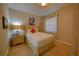 Cozy bedroom with neutral walls, carpet flooring, and window with blinds at 7664 Wilmington Loop, Kissimmee, FL 34747