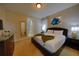 Relaxing bedroom with a comfortable bed, dresser, and a stylish nightstand at 7664 Wilmington Loop, Kissimmee, FL 34747