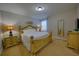 Bedroom featuring a ornate yellow frame King bed, matching furniture and lots of natural light at 7664 Wilmington Loop, Kissimmee, FL 34747