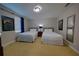 A carpeted bedroom with two beds and themed wall art at 7664 Wilmington Loop, Kissimmee, FL 34747