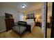 Comfortable bedroom furnished with a queen size bed and dark wooden furniture, plus a crib at 7664 Wilmington Loop, Kissimmee, FL 34747