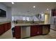 Kitchen with stainless steel appliances, granite countertops, and a breakfast bar at 7664 Wilmington Loop, Kissimmee, FL 34747