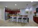 Kitchen features a breakfast bar with seating, stainless steel appliances and dark wood cabinets at 7664 Wilmington Loop, Kissimmee, FL 34747