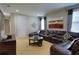 Comfortable living room with a sectional sofa, round coffee table, and stylish curtains at 7664 Wilmington Loop, Kissimmee, FL 34747