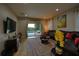 Spacious living room with pool views through sliding glass doors and comfortable seating at 7664 Wilmington Loop, Kissimmee, FL 34747