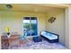 Relaxing outdoor patio features comfortable seating and a table for al fresco dining at 7664 Wilmington Loop, Kissimmee, FL 34747