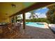 Resort-style pool area features a spa, sun loungers, and lush landscaping for a relaxing retreat at 7664 Wilmington Loop, Kissimmee, FL 34747
