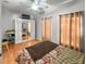 Bright bedroom with hardwood floors, a ceiling fan, and a mirrored wardrobe for ample storage at 7733 Beridale Ct, Orlando, FL 32818