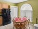 Bright dining area with a round wooden table and chairs, set with red placemats at 7733 Beridale Ct, Orlando, FL 32818