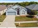 Charming single-Gathering home with a well-maintained lawn, red front door, and a two-car garage at 7733 Beridale Ct, Orlando, FL 32818