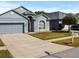 Charming single-Gathering home with a well-maintained lawn, red front door, and a two-car garage at 7733 Beridale Ct, Orlando, FL 32818
