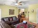 Living room with wood floors, ceiling fan, and comfortable seating area at 7733 Beridale Ct, Orlando, FL 32818