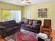 Living room features wood floors, neutral-colored walls and furniture, with access to the outdoors at 7733 Beridale Ct, Orlando, FL 32818