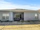 A covered patio with sliding glass doors offers an open-air dining space for this home at 7733 Beridale Ct, Orlando, FL 32818