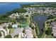 Expansive aerial view of the community, featuring multiple lakes, a pool, tennis court, and well-spaced homes at 786 Seneca Meadows Rd, Winter Springs, FL 32708