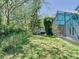 Lush backyard with green grass, mature trees and screened lanai at 786 Seneca Meadows Rd, Winter Springs, FL 32708