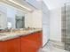 Modern bathroom showcasing double sinks, stylish cabinetry, large mirror, and glass-enclosed shower at 786 Seneca Meadows Rd, Winter Springs, FL 32708
