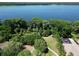 Aerial shot of a community amenity featuring lake access, a beach volleyball court, and lush greenery at 786 Seneca Meadows Rd, Winter Springs, FL 32708