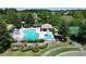 Resort-style community pool with ample lounge chairs, splash pad, and a lakeside view, perfect for relaxation and recreation at 786 Seneca Meadows Rd, Winter Springs, FL 32708