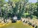 Scenic view of a wooden fishing dock extending into the lake, surrounded by lush greenery and natural beauty at 786 Seneca Meadows Rd, Winter Springs, FL 32708