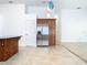 Full sized stainless fridge and wood cabinetry in an open-concept kitchen at 786 Seneca Meadows Rd, Winter Springs, FL 32708