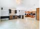 Spacious kitchen with wooden cabinets, wine cooler, marble backsplash and tile flooring throughout the home at 786 Seneca Meadows Rd, Winter Springs, FL 32708